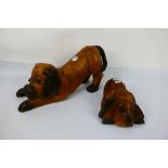 Two carved wood models of dogs, largest approximately 23 cm (h). [2].