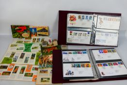 Two binders of first day covers, albums of tea cards and a small quantity of cigarette cards.