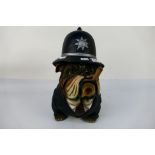 A model depicting an English Bulldog in police uniform smoking a cigar, approximately 39 cm (h).