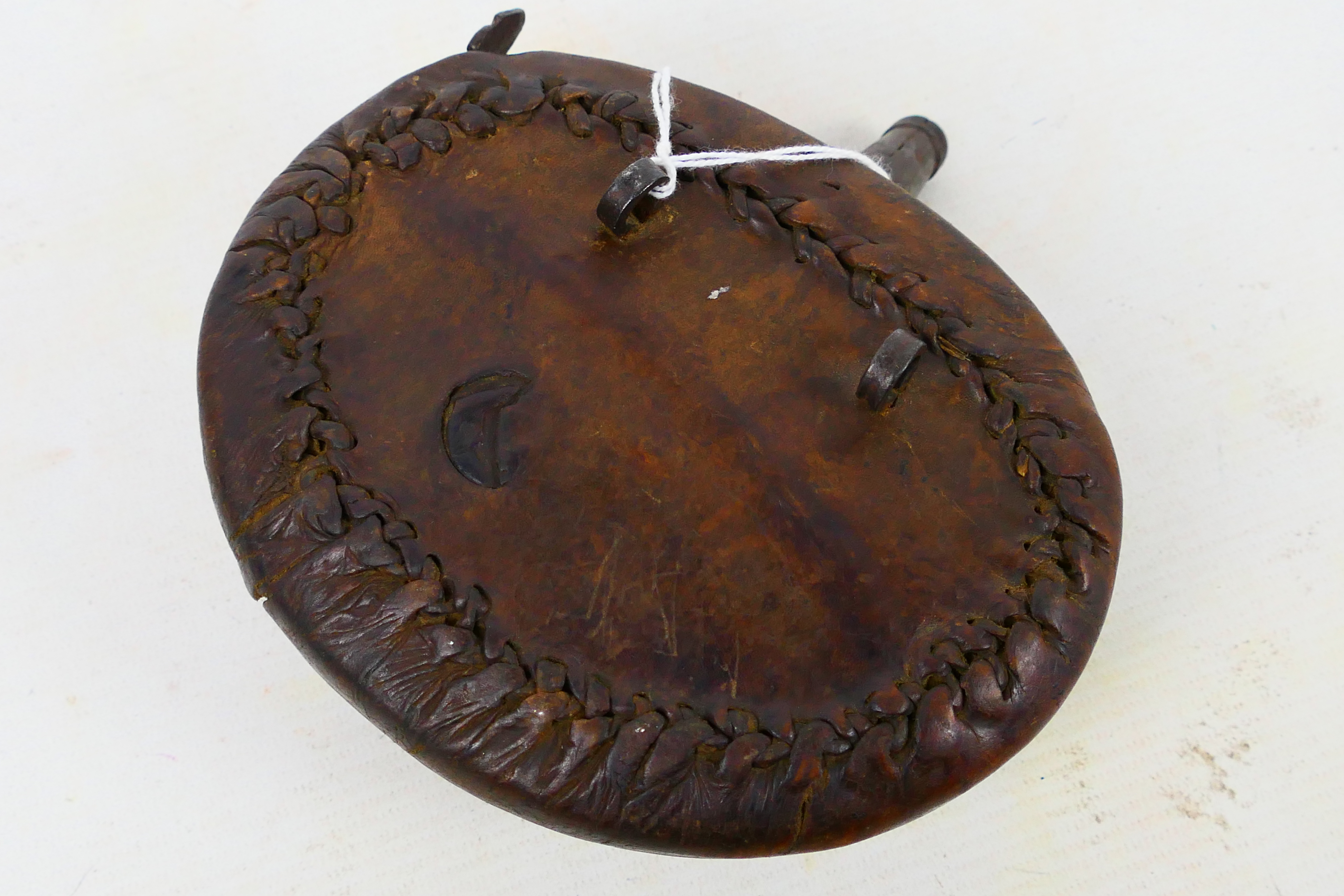 An antique leather clad powder flask, possibly Afghan or Indian, approximately 16 cm (l). - Image 3 of 4