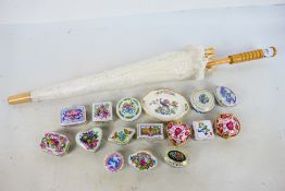 A collection of small porcelain trinket boxes and similar and a lacework parasol. [2].