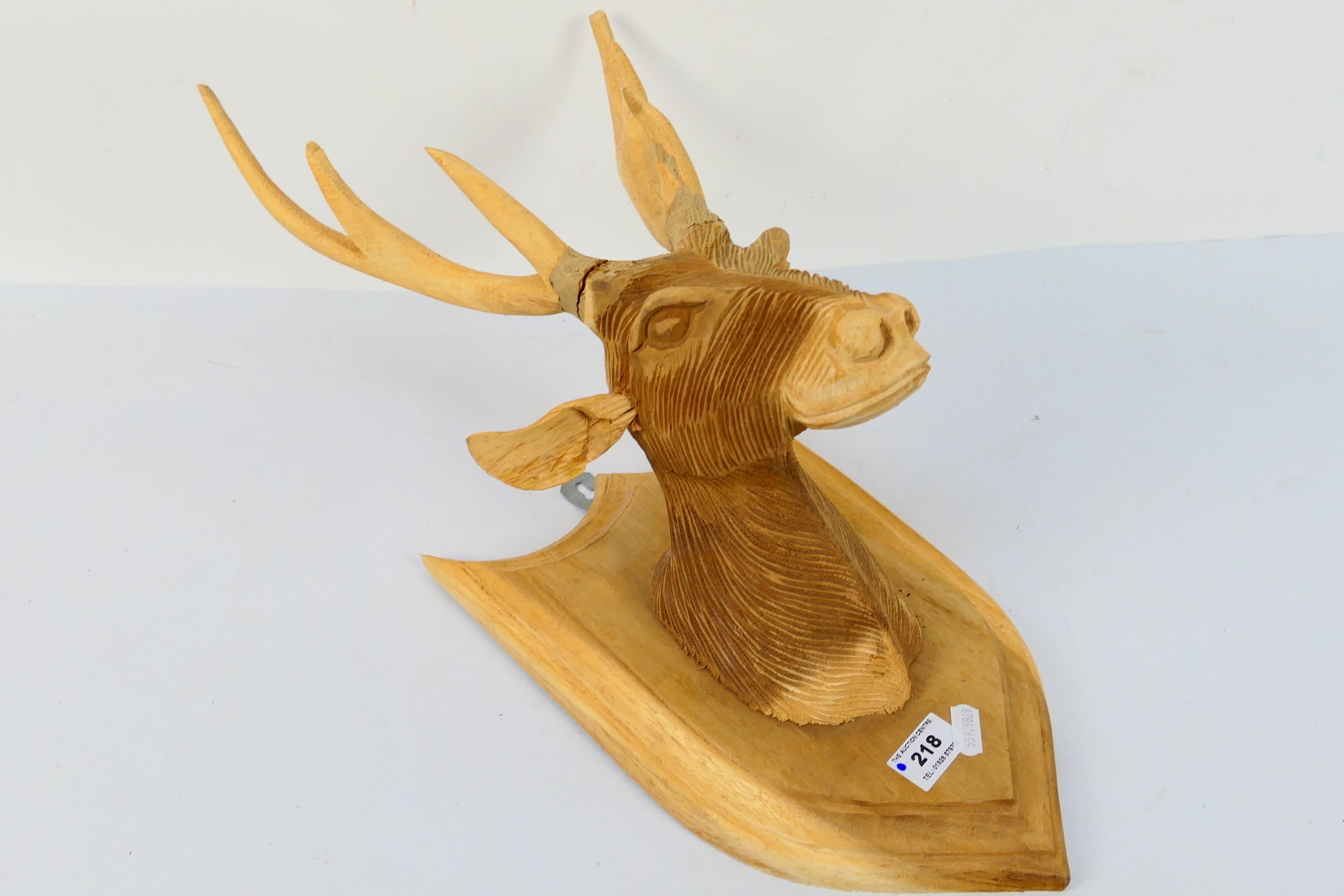 A carved wood hunting trophy on shield mount, approximately 47 cm.