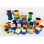 A collection of Torquay pottery wares to include bowls, jugs, cups and other, various manufacturers.