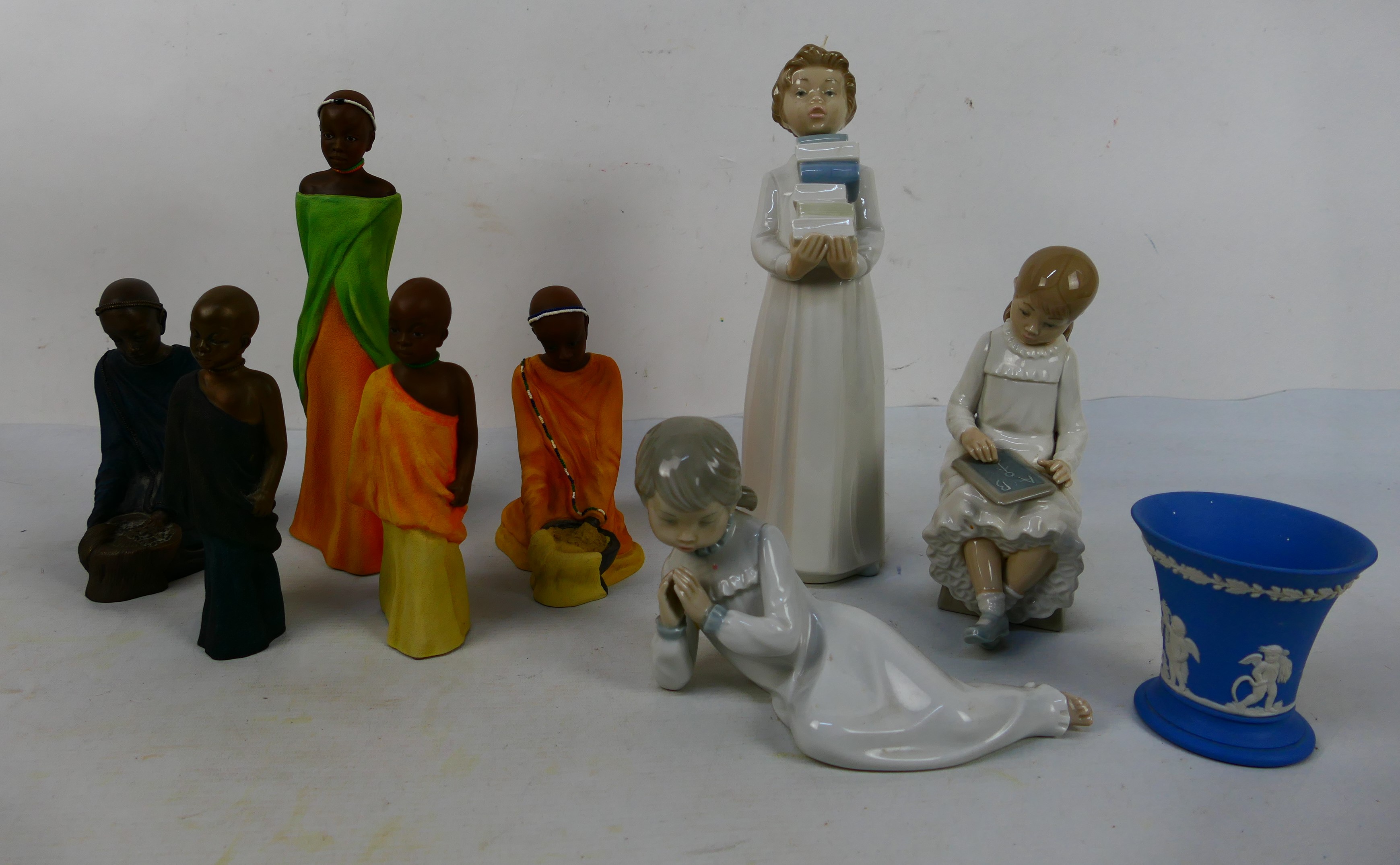 A group of ceramic figurines and similar to include three by Nao,