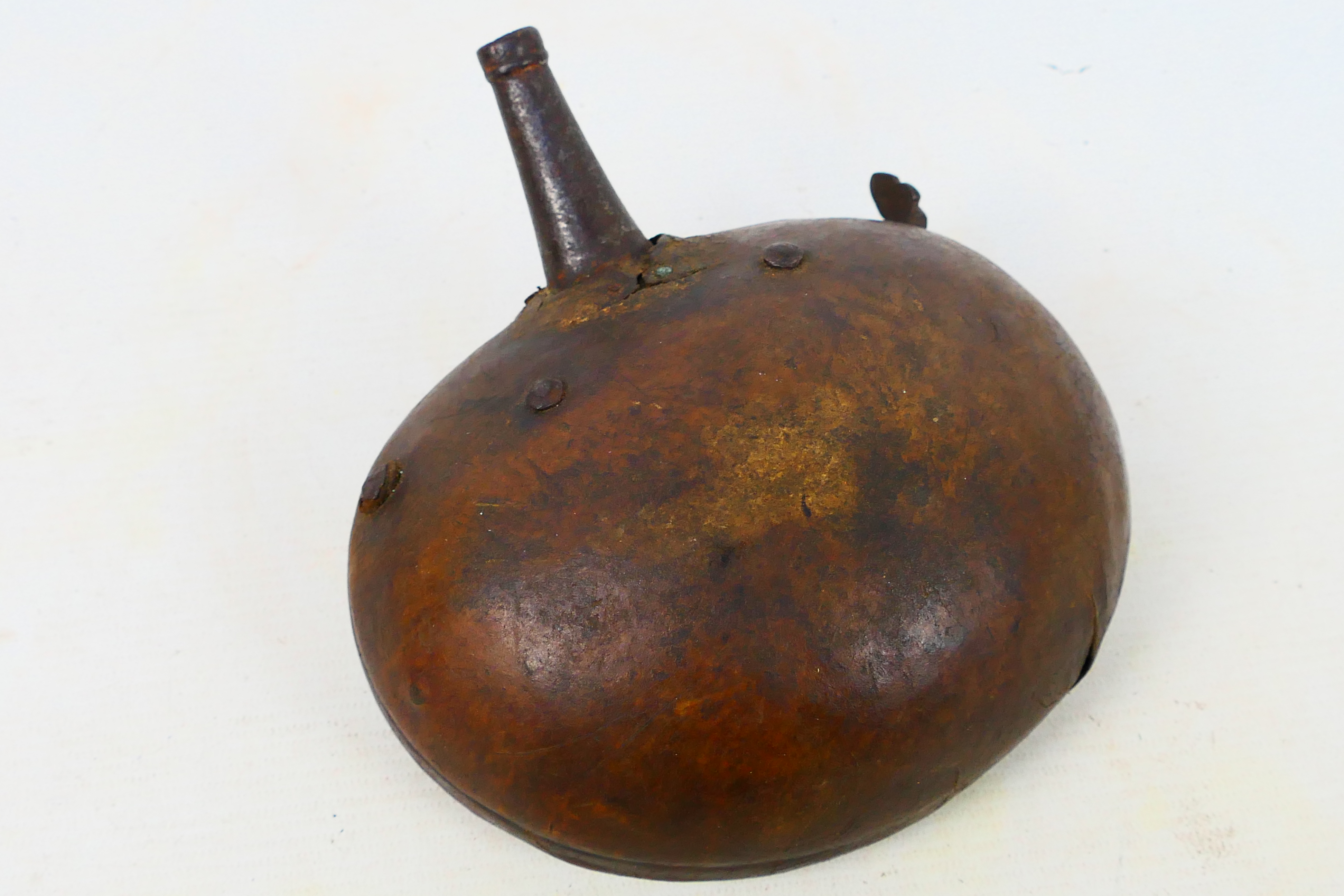 An antique leather clad powder flask, possibly Afghan or Indian, approximately 16 cm (l). - Image 2 of 4