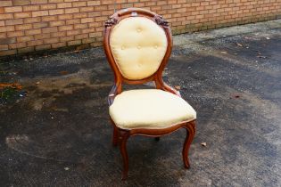 An upholstered bedroom chair with carved
