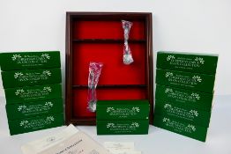 A Charles Dickens Christmas Carol Spoon Collection comprising of twelve boxed pewter spoons and a
