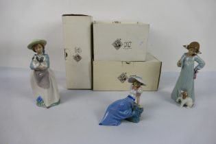 Three boxed Nao figures comprising # 1042, # 1163 and other, largest approximately 25 cm (h). [3].