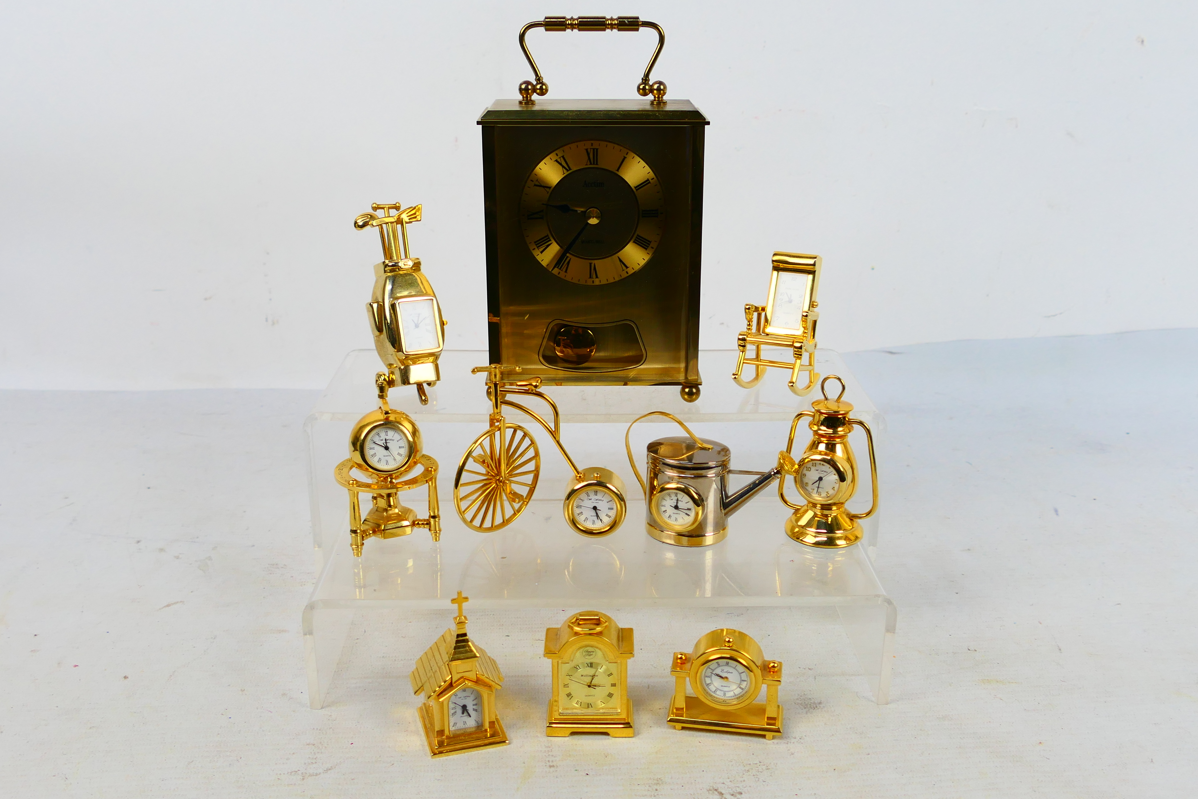 A collection of clocks, predominantly miniature novelty clocks.