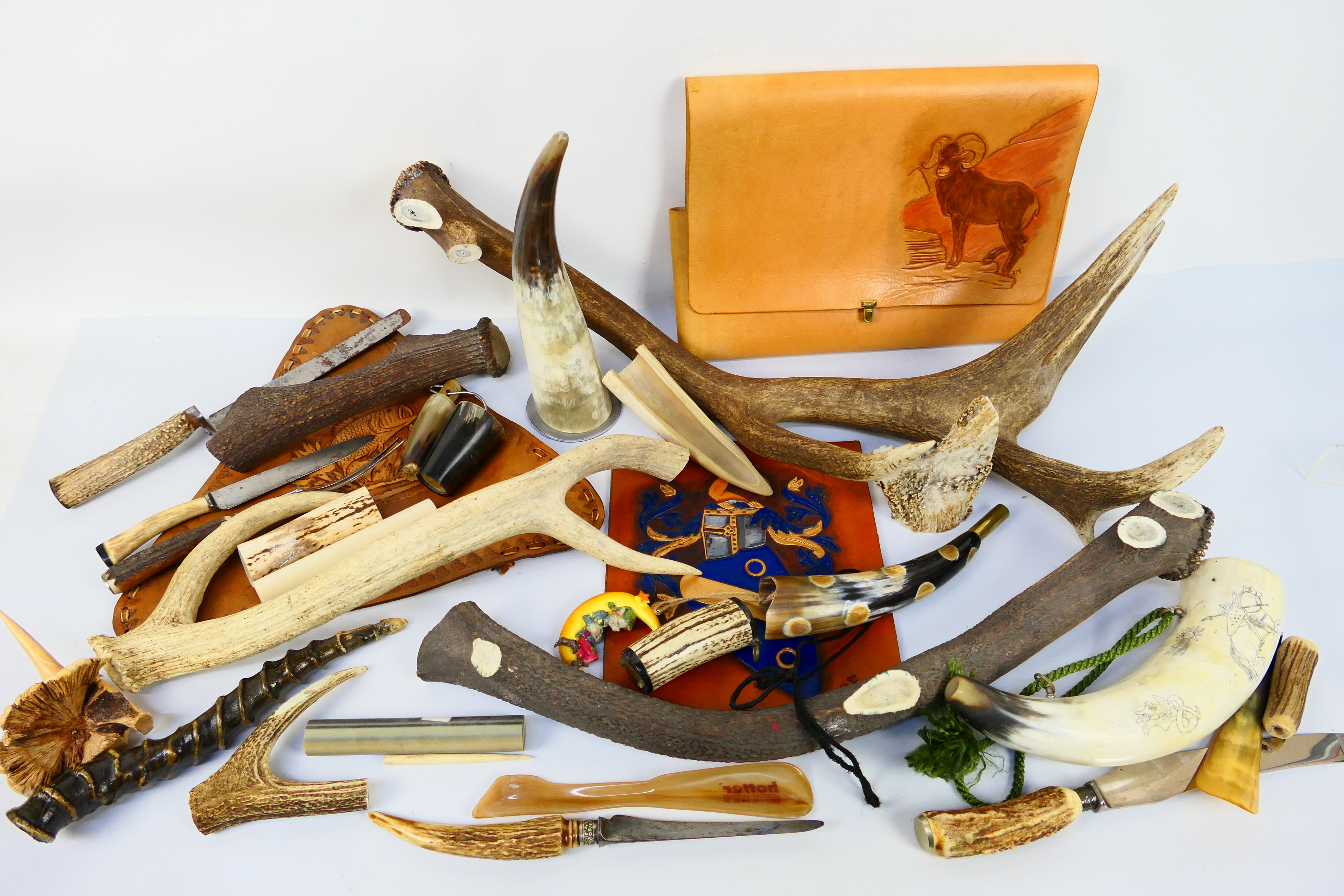Various horn and antler pieces and tooled leather items.