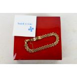 A 9ct yellow gold gate link bracelet set with three small diamonds, approximately 18 cm (l), 7.