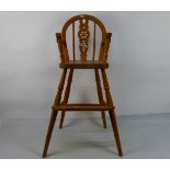 A pine high chair with footrest and pierced splat, 83 cm (h).