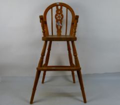 A pine high chair with footrest and pierced splat, 83 cm (h).