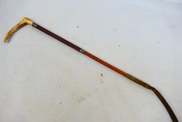A horn handled, leather clad riding crop with silver mounts, London assay (marks rubbed), 60 cm (l).