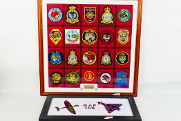 A framed display of aviation related cloth patches of attending squadrons from the NATO Tiger Meet
