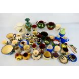 A collection of Torquay pottery wares to include bowls, jugs, cups,