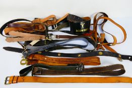 A collection of vintage leather belts and similar.