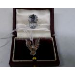 A white metal, ruby set pin brooch by Asprey of London,