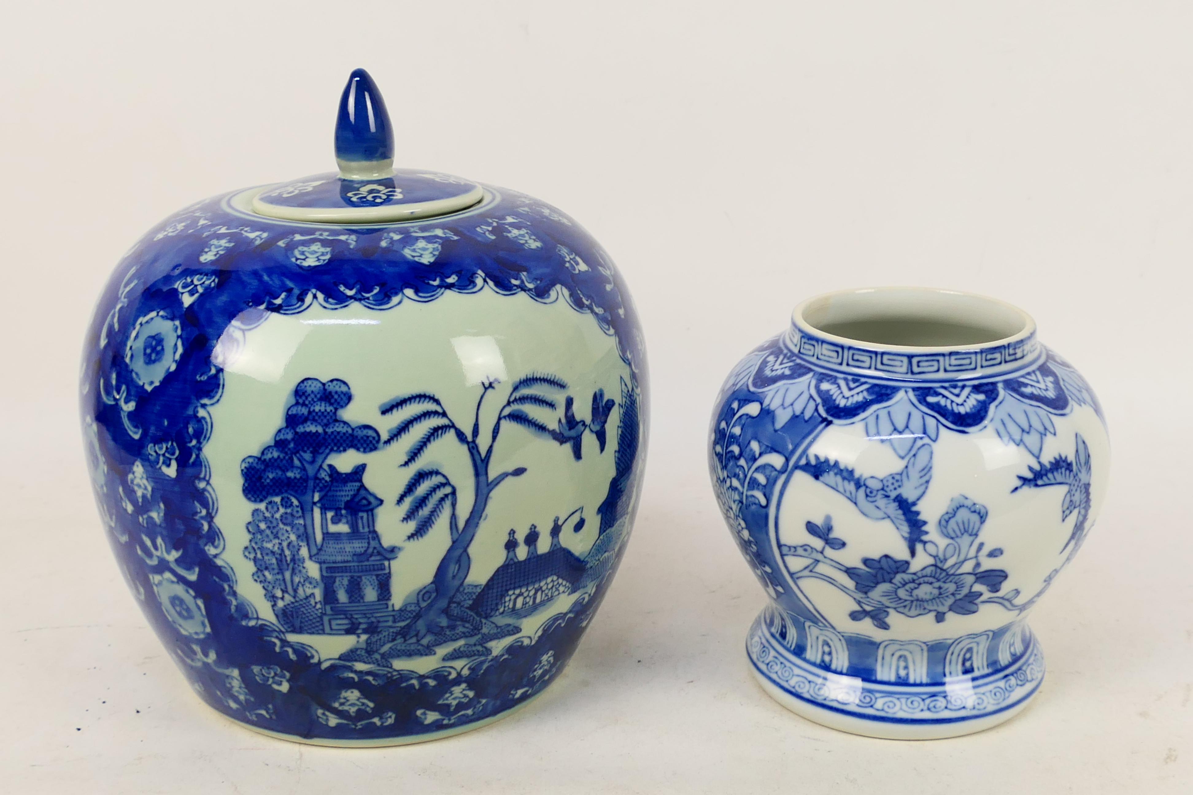 A blue and white vase of squat meiping form decorated with birds and flowers and a large blue and