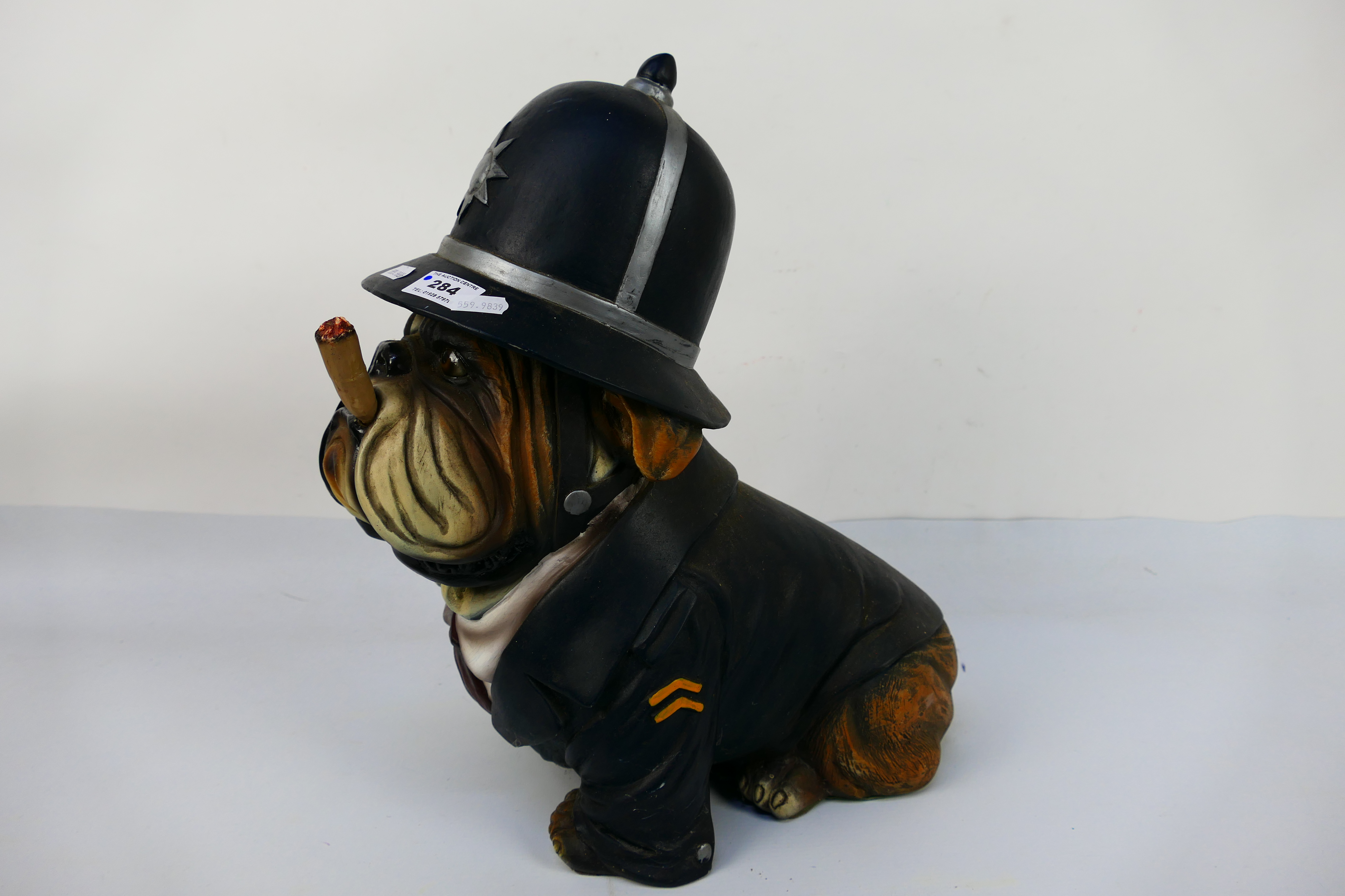 A model depicting an English Bulldog in police uniform smoking a cigar, approximately 39 cm (h). - Image 2 of 3