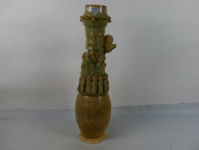 A Chinese Song style funerary vase, the ovoid body with slender neck decorated with applied figures,
