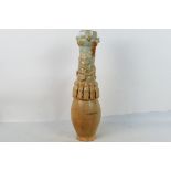 A Chinese Song style funerary vase, the ovoid body with slender neck decorated with applied figures,