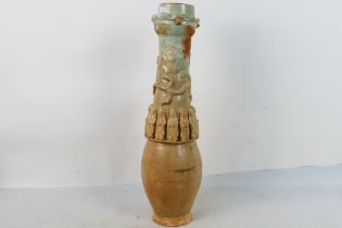 A Chinese Song style funerary vase, the ovoid body with slender neck decorated with applied figures,