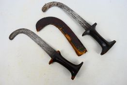 Ethnographica - Two Sudanese knives, curved steel blades with waisted grips,