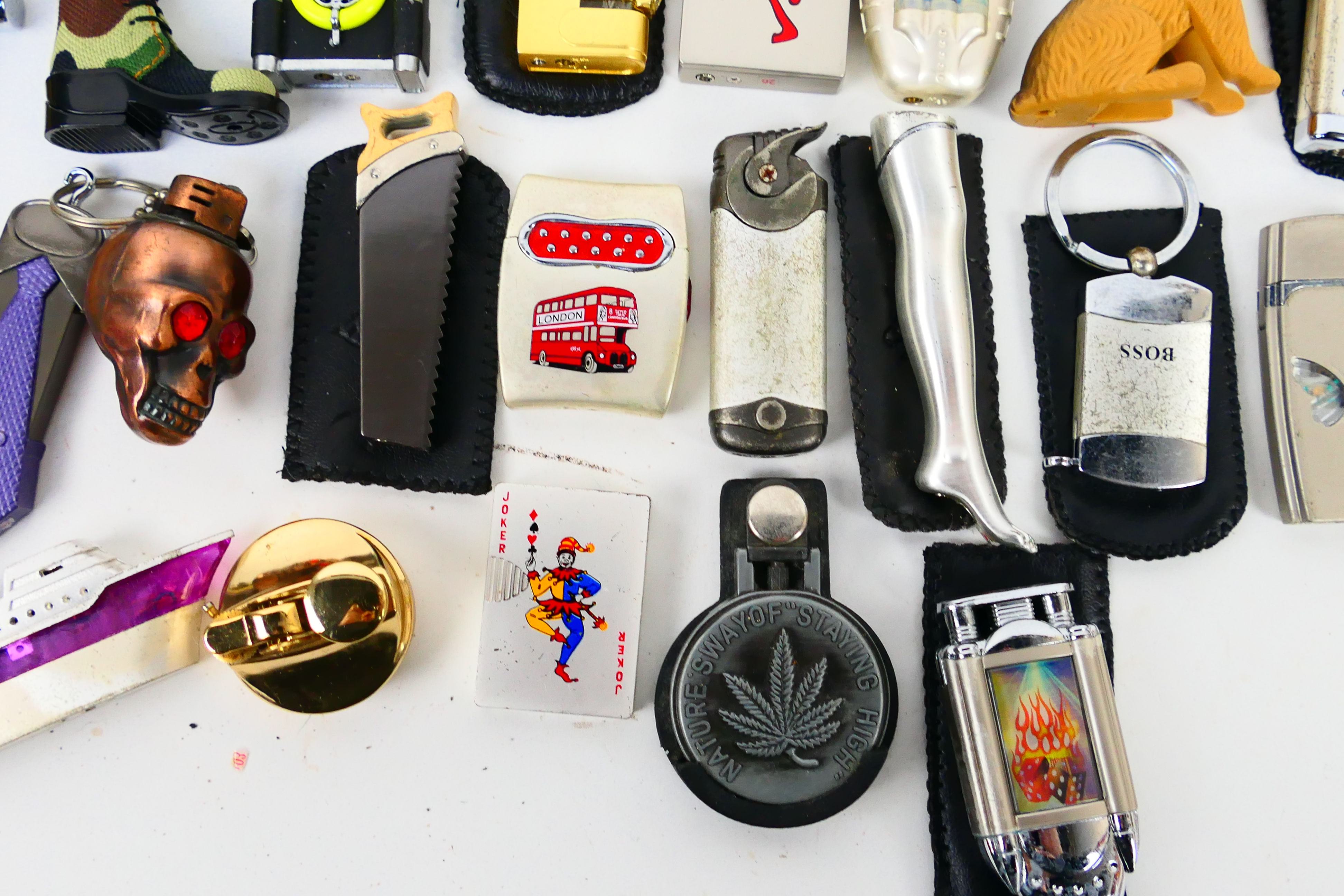 A collection of novelty cigarette lighters and protective cases. - Image 4 of 7