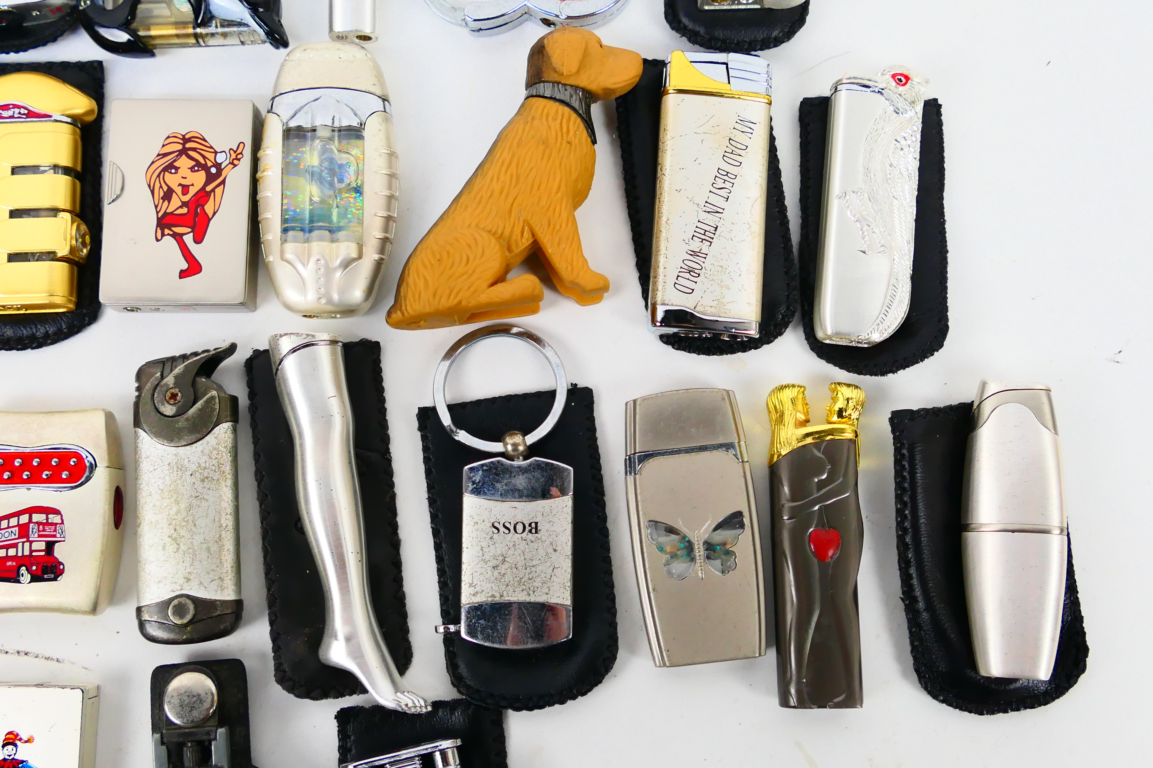 A collection of novelty cigarette lighters and protective cases. - Image 5 of 7