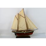 A model boat mounted to wooden display p