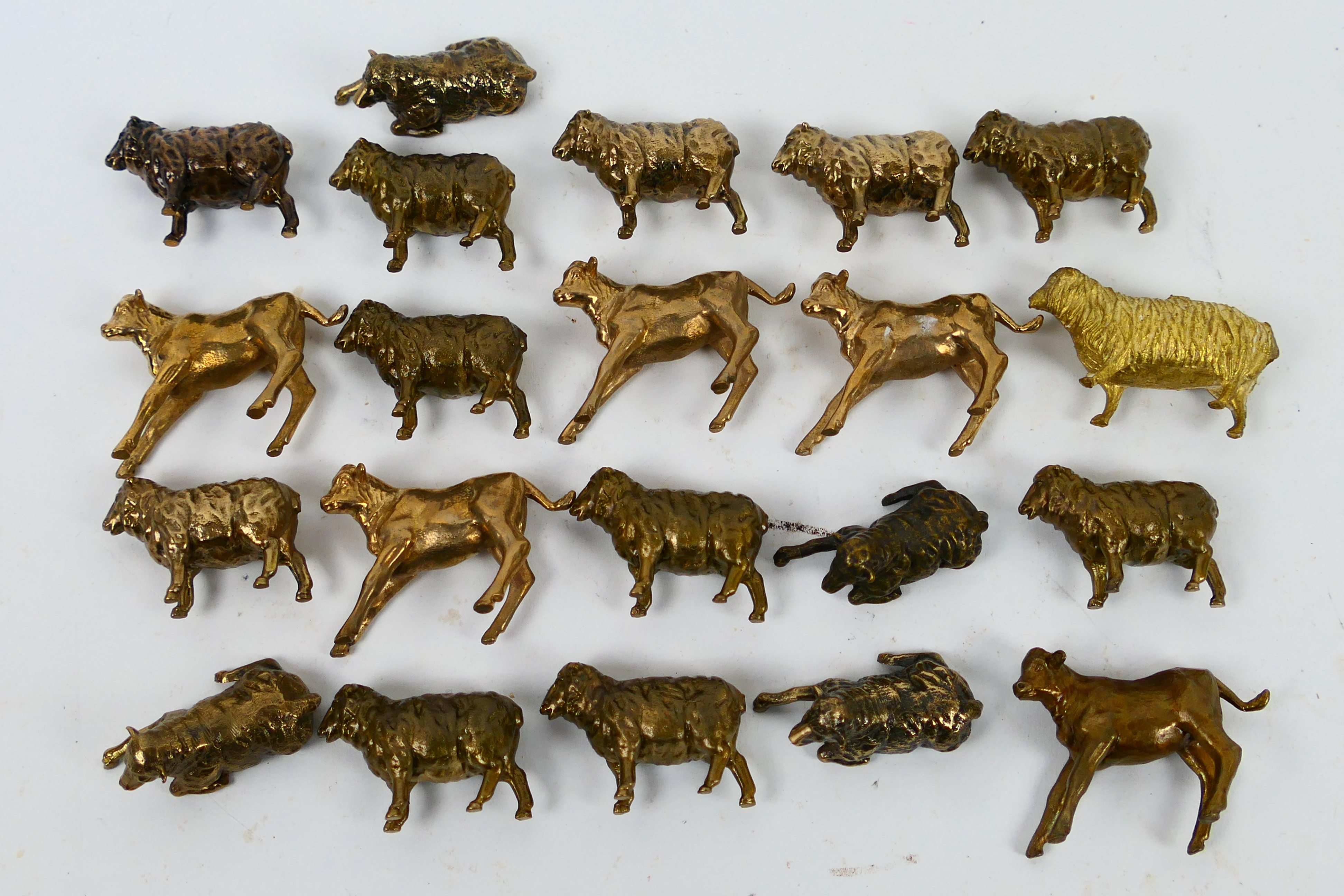 A collection of bronze animal figures, sheep and calf, approximately 4 cm (l).