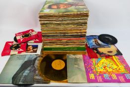 A collection of 12" and 7" vinyl records to include John Lennon, Kool & The Gang,