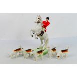 Beswick hunting figures comprising huntsman on rearing white horse # 868 and five fox hounds,