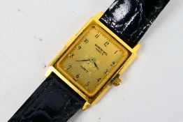 A lady's 18ct gold plated wrist watch on black leather strap.