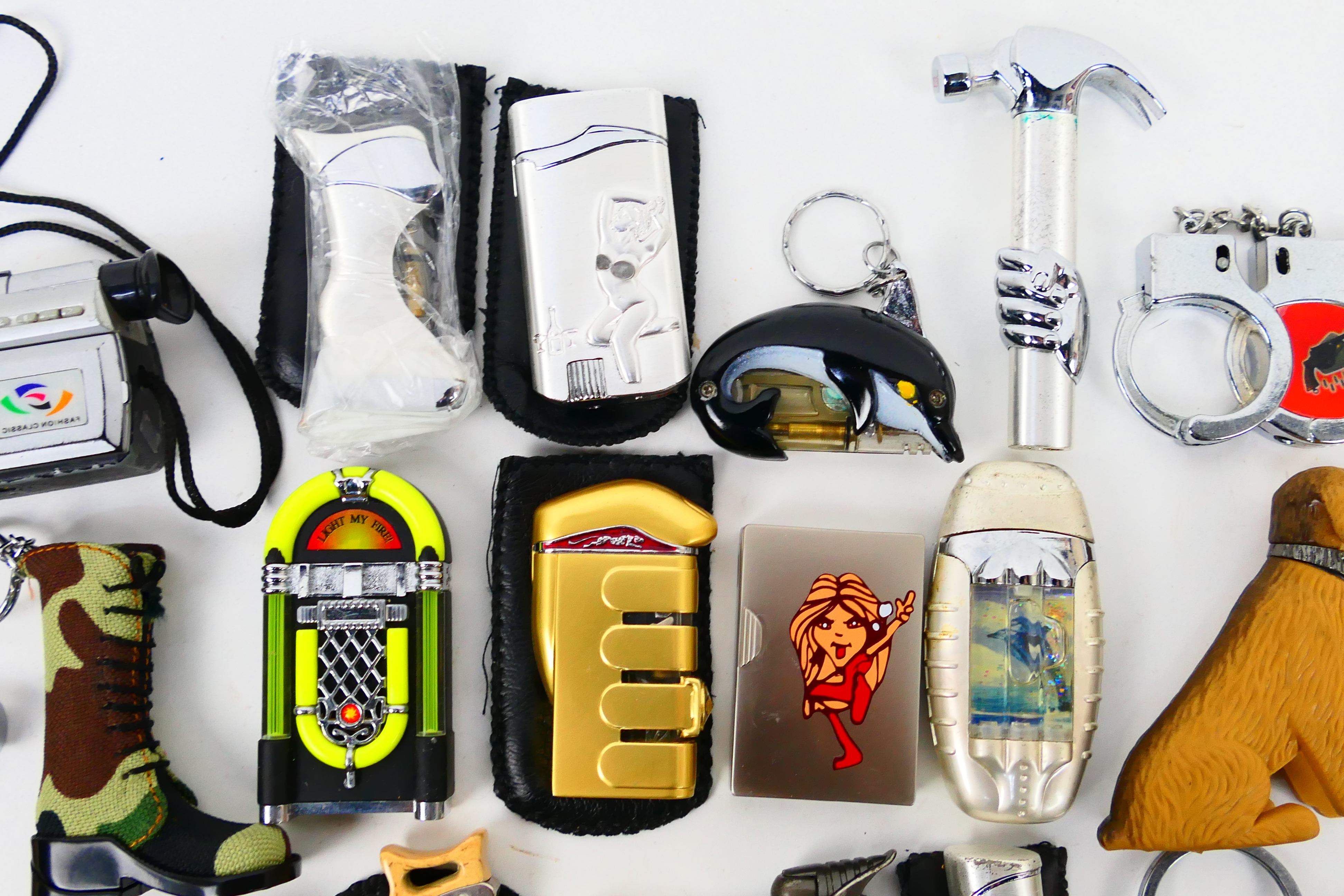 A collection of novelty cigarette lighters and protective cases. - Image 7 of 7