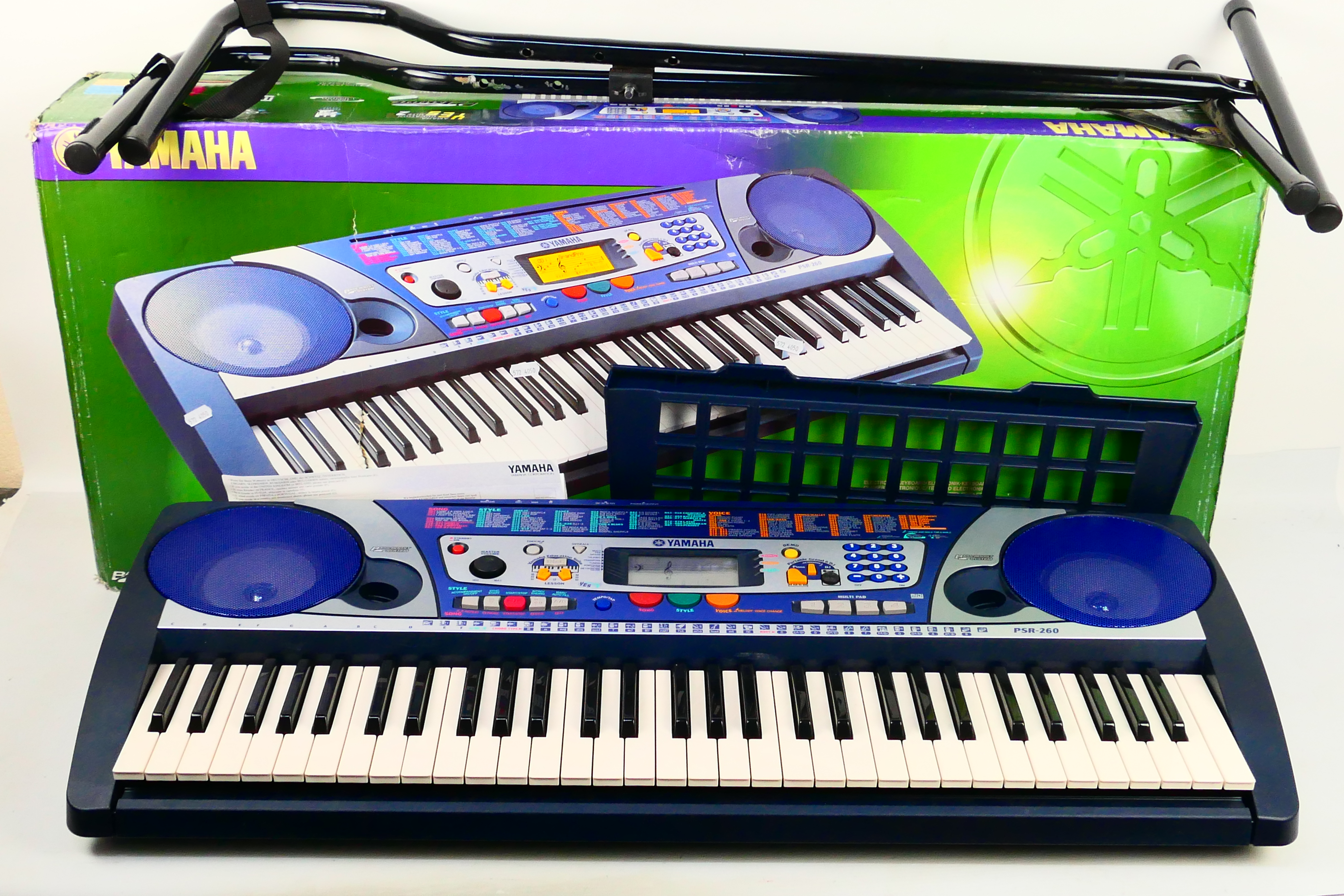 A boxed Yamaha PSR-260 electronic keyboard and stand.
