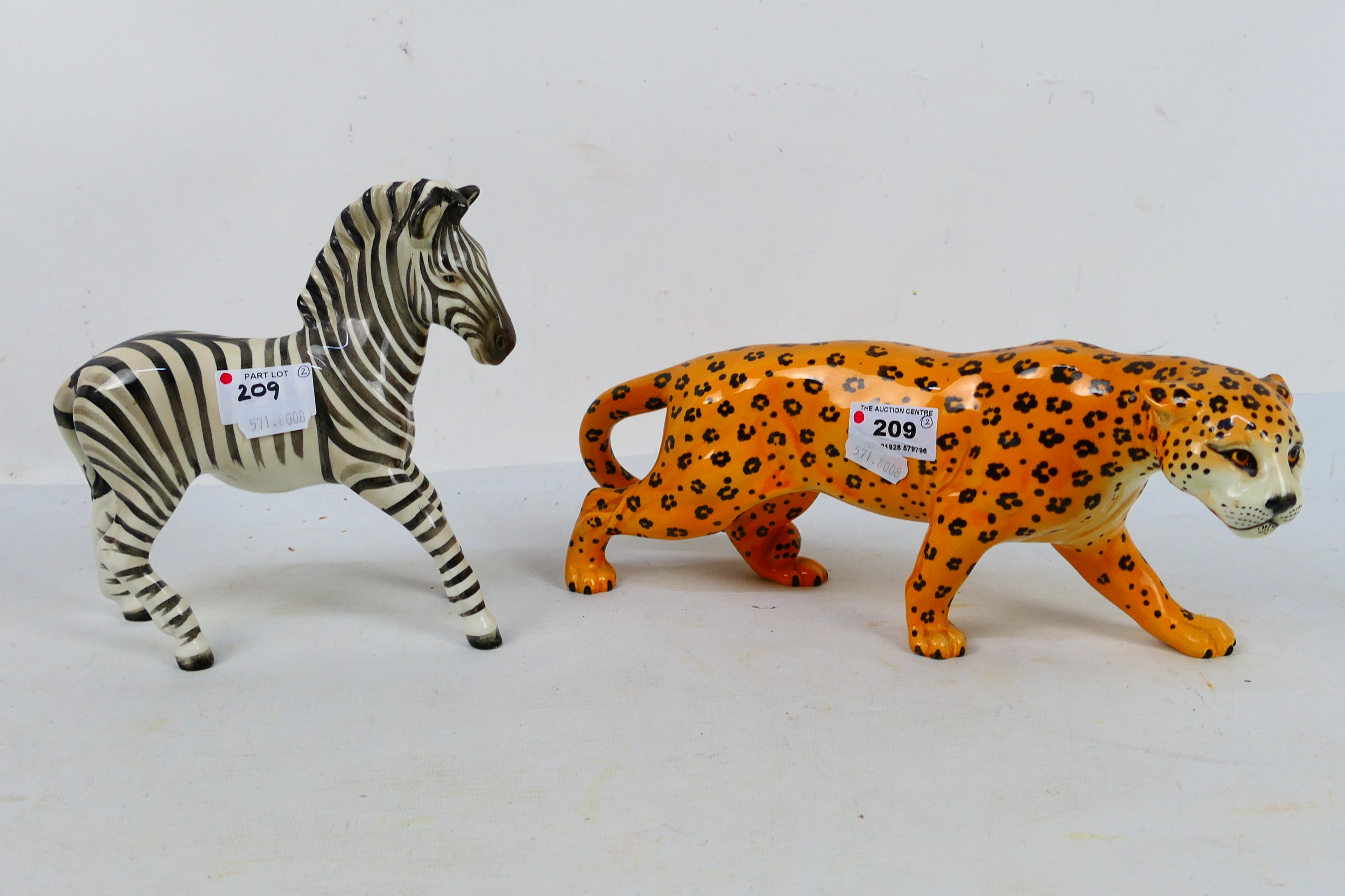 Two Beswick animal studies comprising leopard and zebra, largest approximately 30 cm (l). [2].