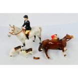 Four Beswick hunting figures comprising huntsman on brown horse and huntswoman on grey,