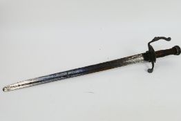 An antique hunting short sword, probably 18th century, iron shell guard, 62 cm (l) blade.