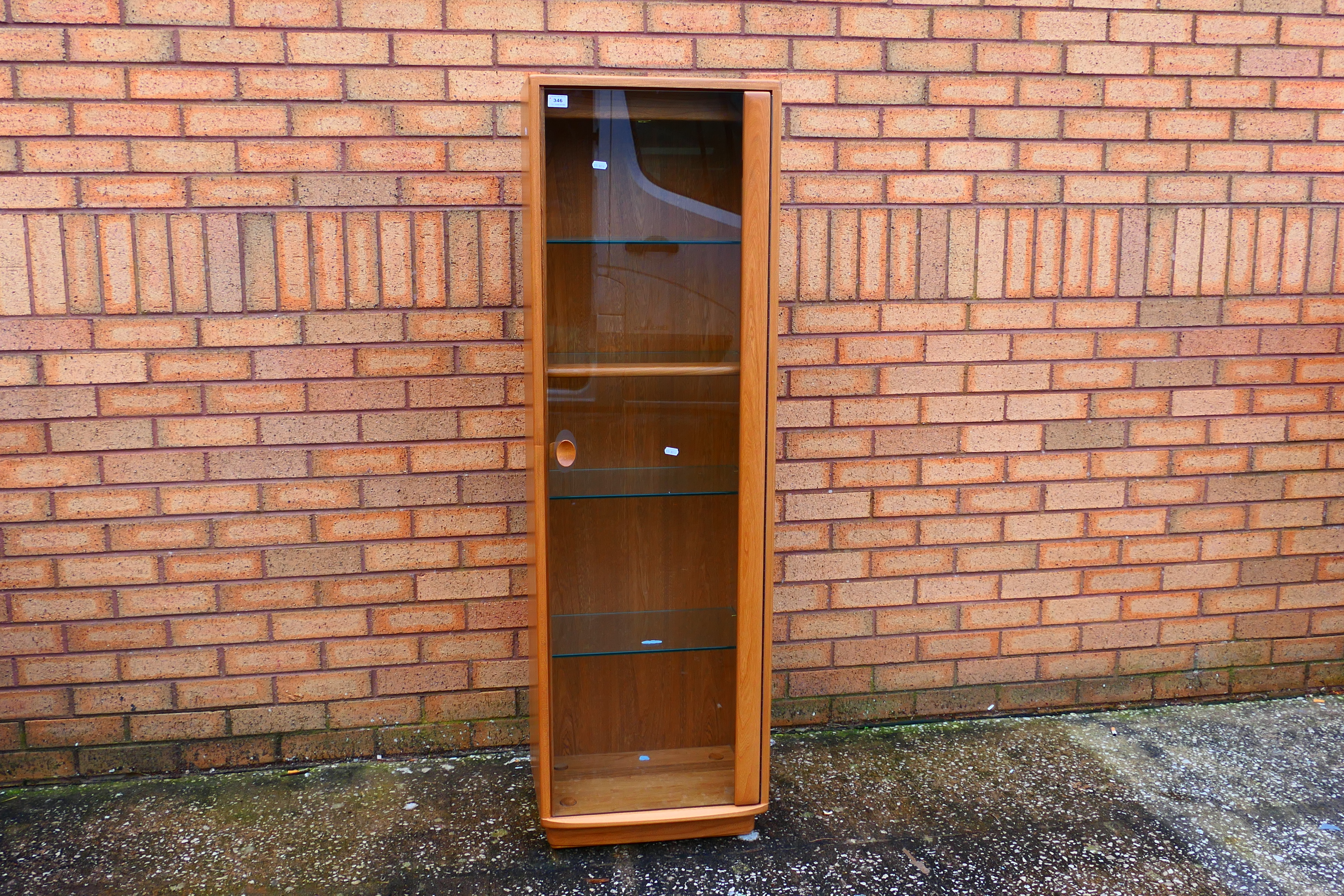 Ercol - A Windsor single door display cabinet with adjustable shelves,