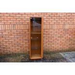 Ercol - A Windsor single door display cabinet with adjustable shelves,