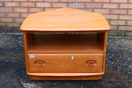 An Ercol Windsor model 1130 corner drop-leaf television stand, with single drawer,