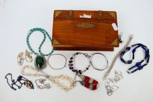 A collection of costume jewellery to include brooches, bracelets, necklaces and other,