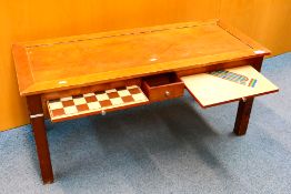 A wooden coffee / games table measuring approximately 40 cm x 102 cm x 42 cm.