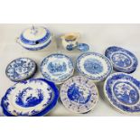 A collection of blue and white ceramics, predominantly plates.