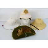 Three pith helmets, one with 24th Regime