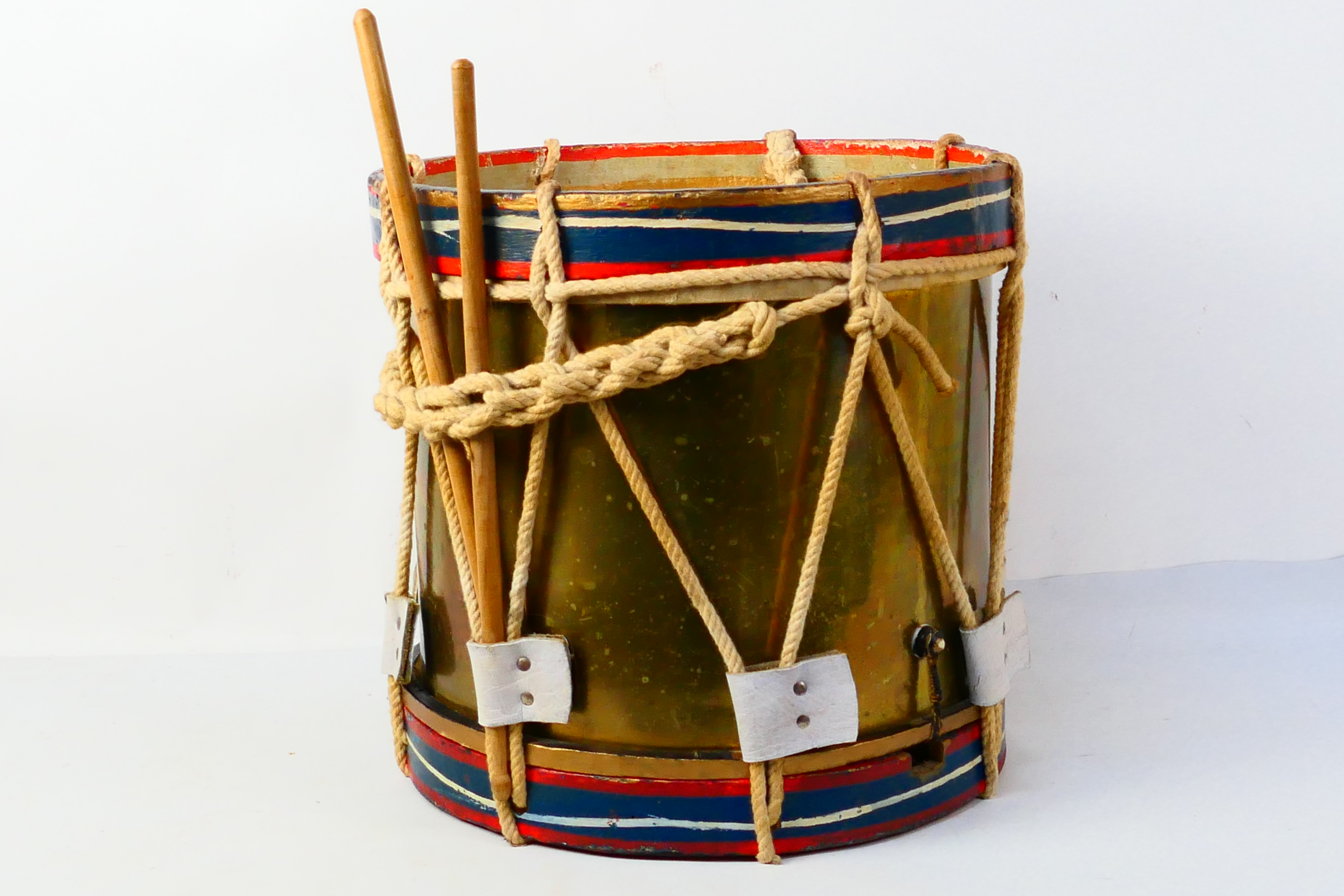 A vintage marching drum, approximately 3