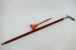 A walking stick with chrome jaguar form handle and a copper hunting horn. [2].