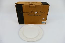 A boxed sixteen piece dining collection with strawberry embossed decoration.